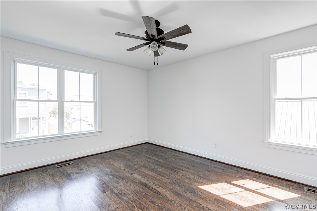 2403 Everett Street Richmond, VA 23224 - Photo 22 of 25 an empty room with wooden floor fan and windows