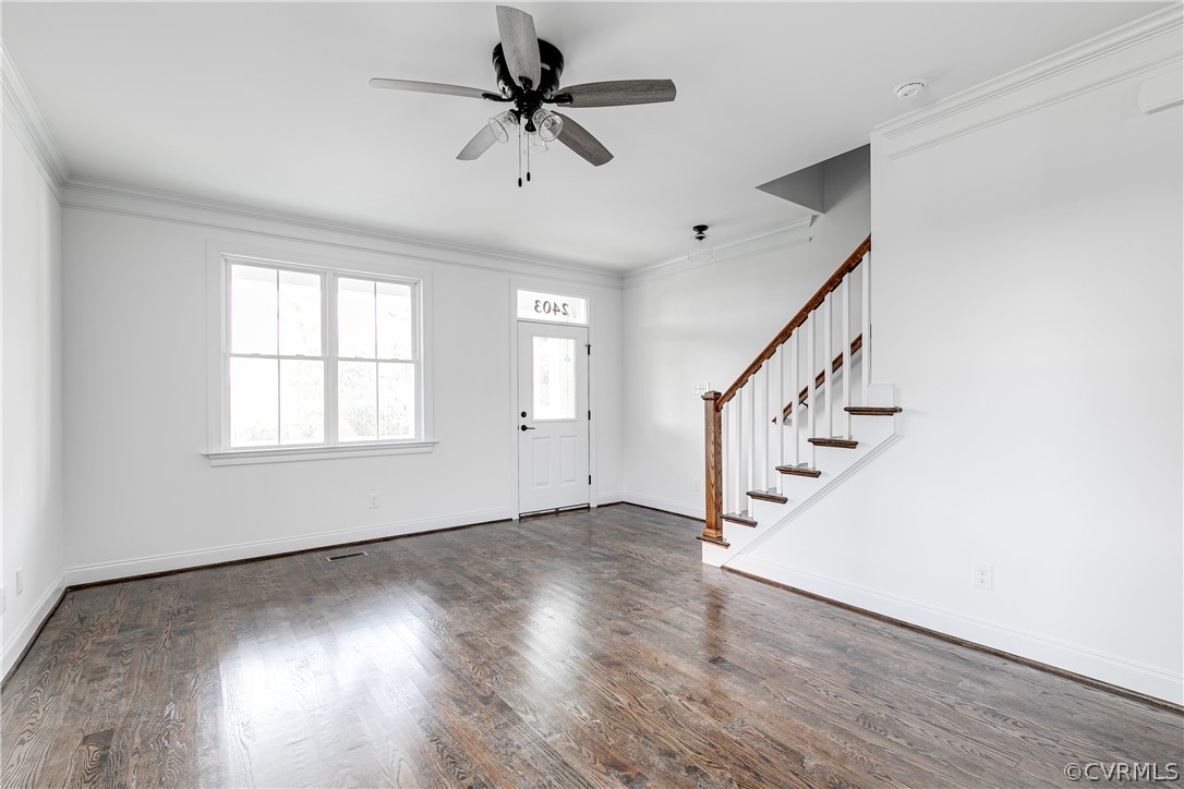 2403 Everett Street Richmond, VA 23224 - Photo 4 of 25 an empty room with wooden floor fan and windows