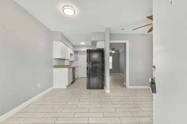 a view of a kitchen with a sink and refrigerator