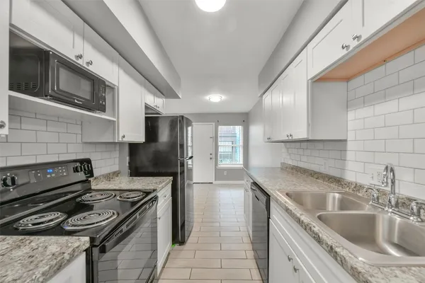 a kitchen that has a sink and a stove