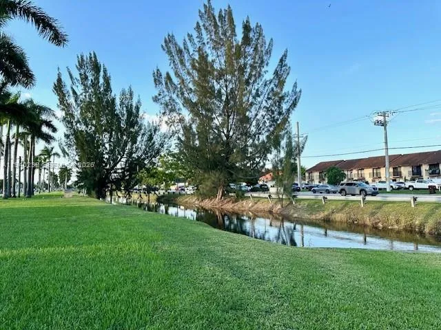 a view of a backyard with swimming pool