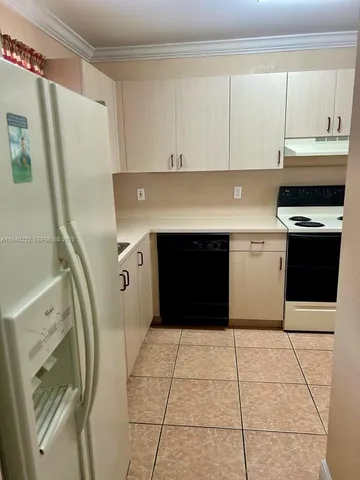 a kitchen with stainless steel appliances granite countertop a stove a refrigerator and a cabinets