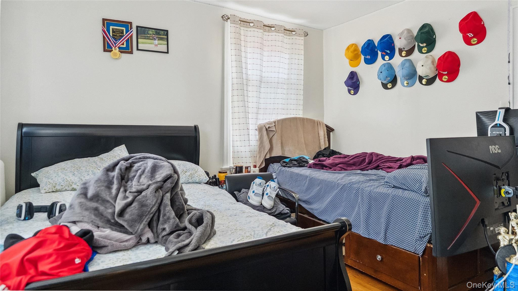 56-12 135th Street Queens, NY 11355 - Photo 12 of 23 a view of a couch in a bedroom