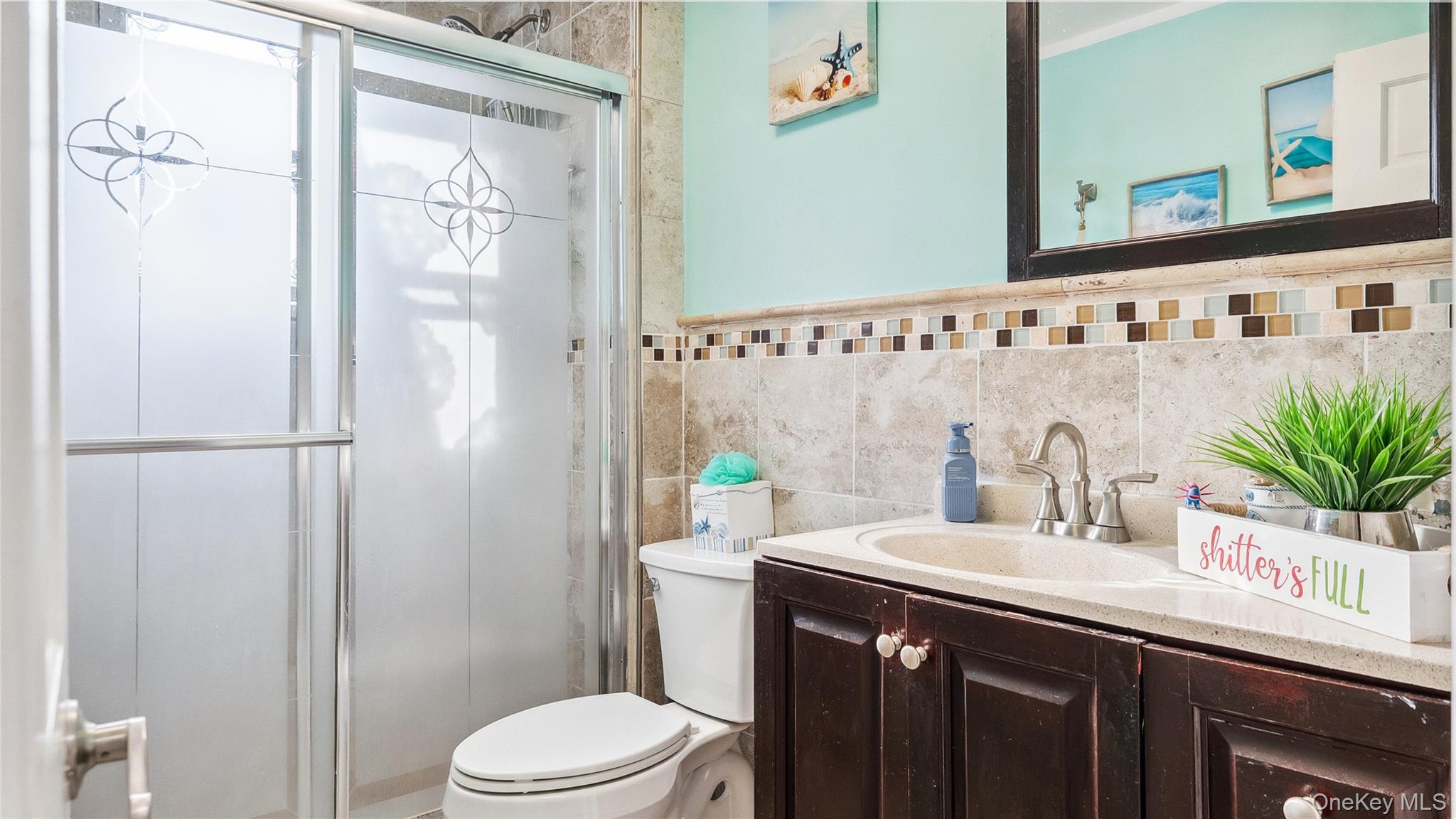 56-12 135th Street Queens, NY 11355 - Photo 16 of 23 a bathroom with a sink a toilet and shower curtain