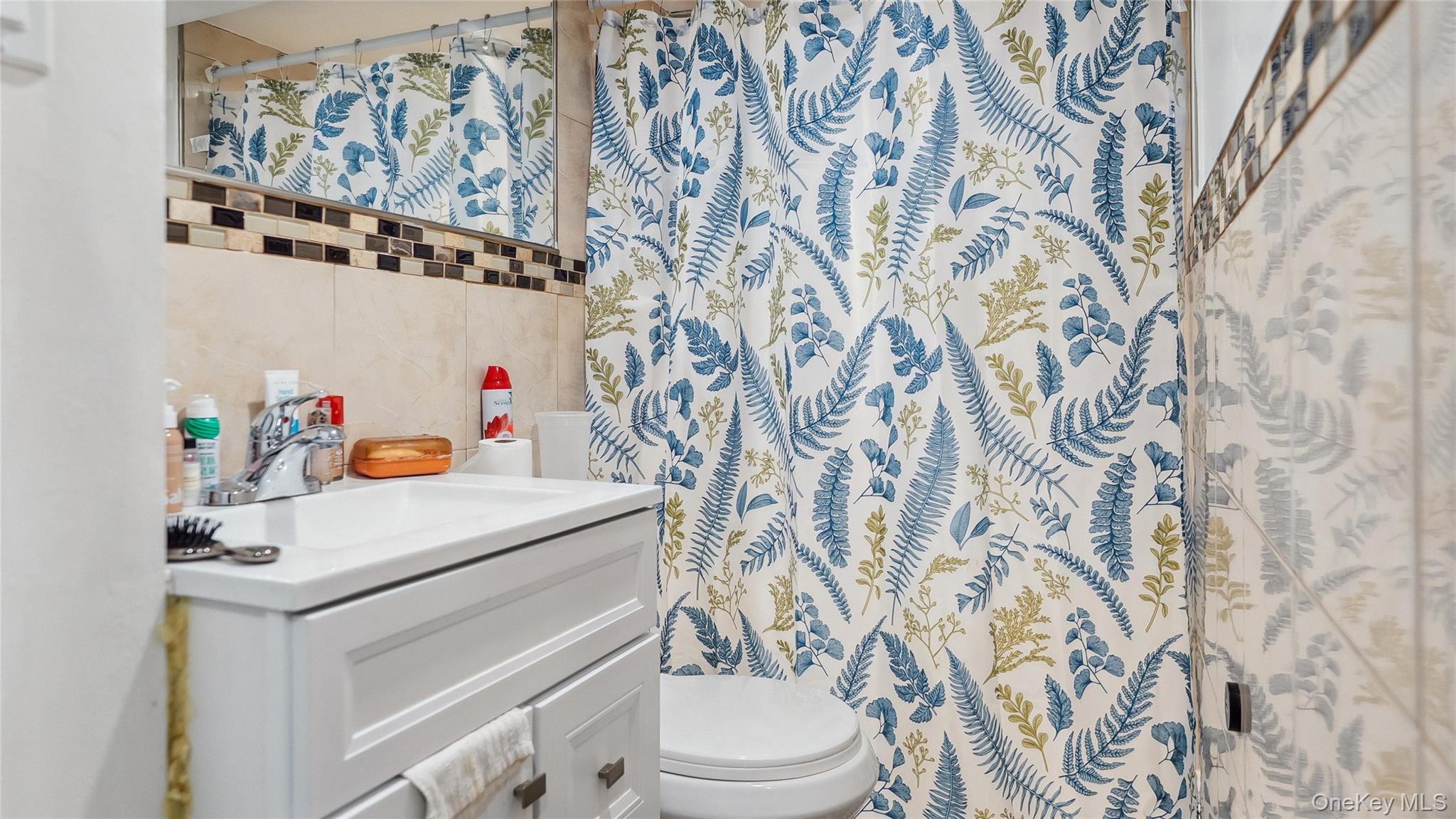 56-12 135th Street Queens, NY 11355 - Photo 17 of 23 a bathroom with a toilet and a sink