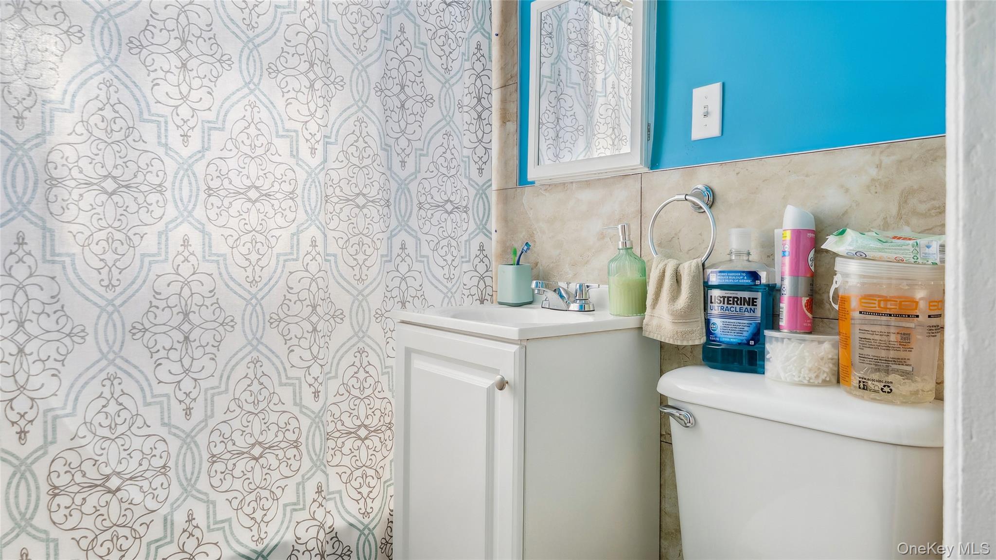 56-12 135th Street Queens, NY 11355 - Photo 18 of 23 a bathroom with a sink and a washer dryer