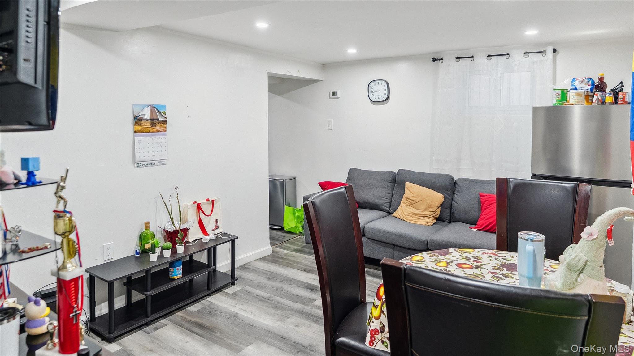 56-12 135th Street Queens, NY 11355 - Photo 19 of 23 a living room with furniture and a flat screen tv