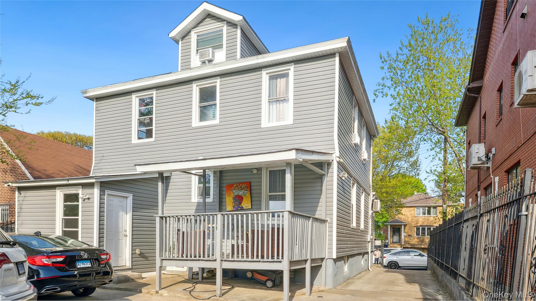 56-12 135th Street Queens, NY 11355 - Photo 2 of 23 a front view of a house with a yard