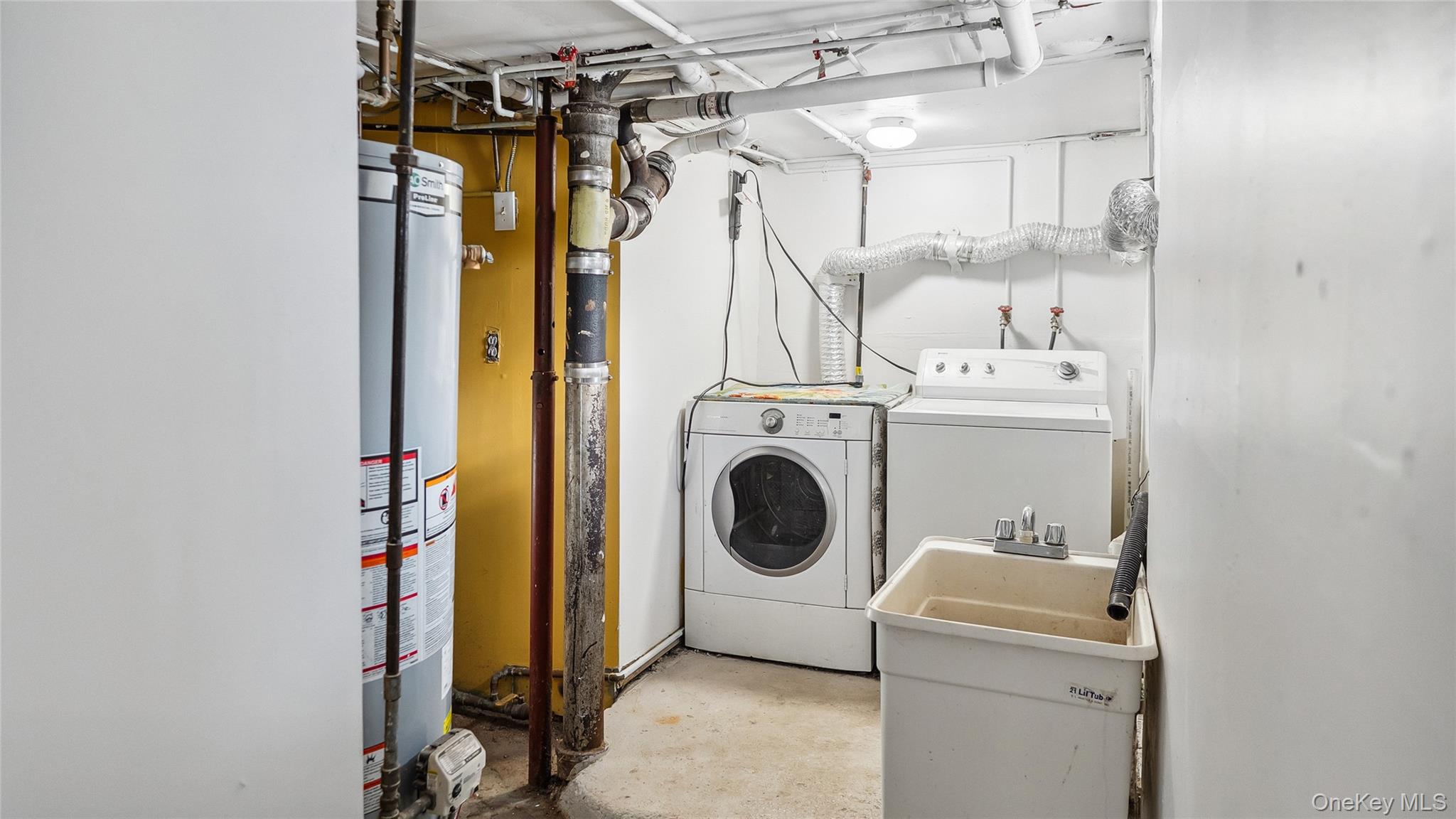56-12 135th Street Queens, NY 11355 - Photo 21 of 23 a utility room with dryer and washer