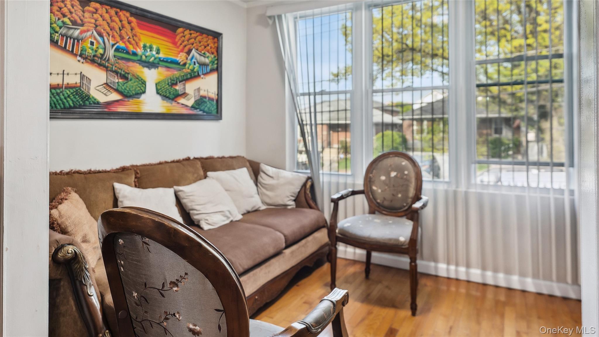 56-12 135th Street Queens, NY 11355 - Photo 5 of 23 a living room with furniture and a floor to ceiling window