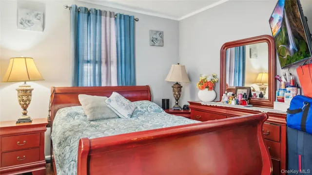 a bedroom with bed and wooden floor