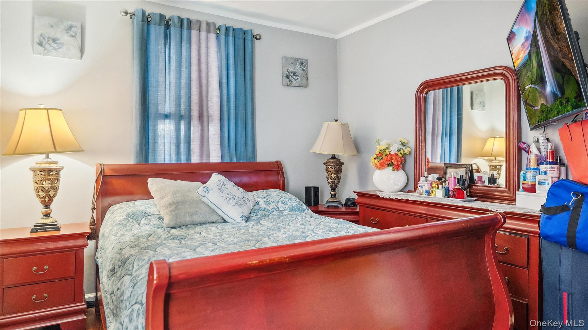 56-12 135th Street Queens, NY 11355 - Photo 9 of 23 a bedroom with bed and window