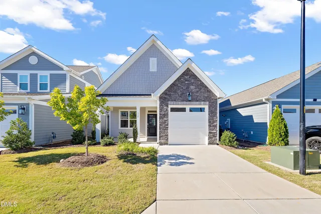 a front view of a house with yard