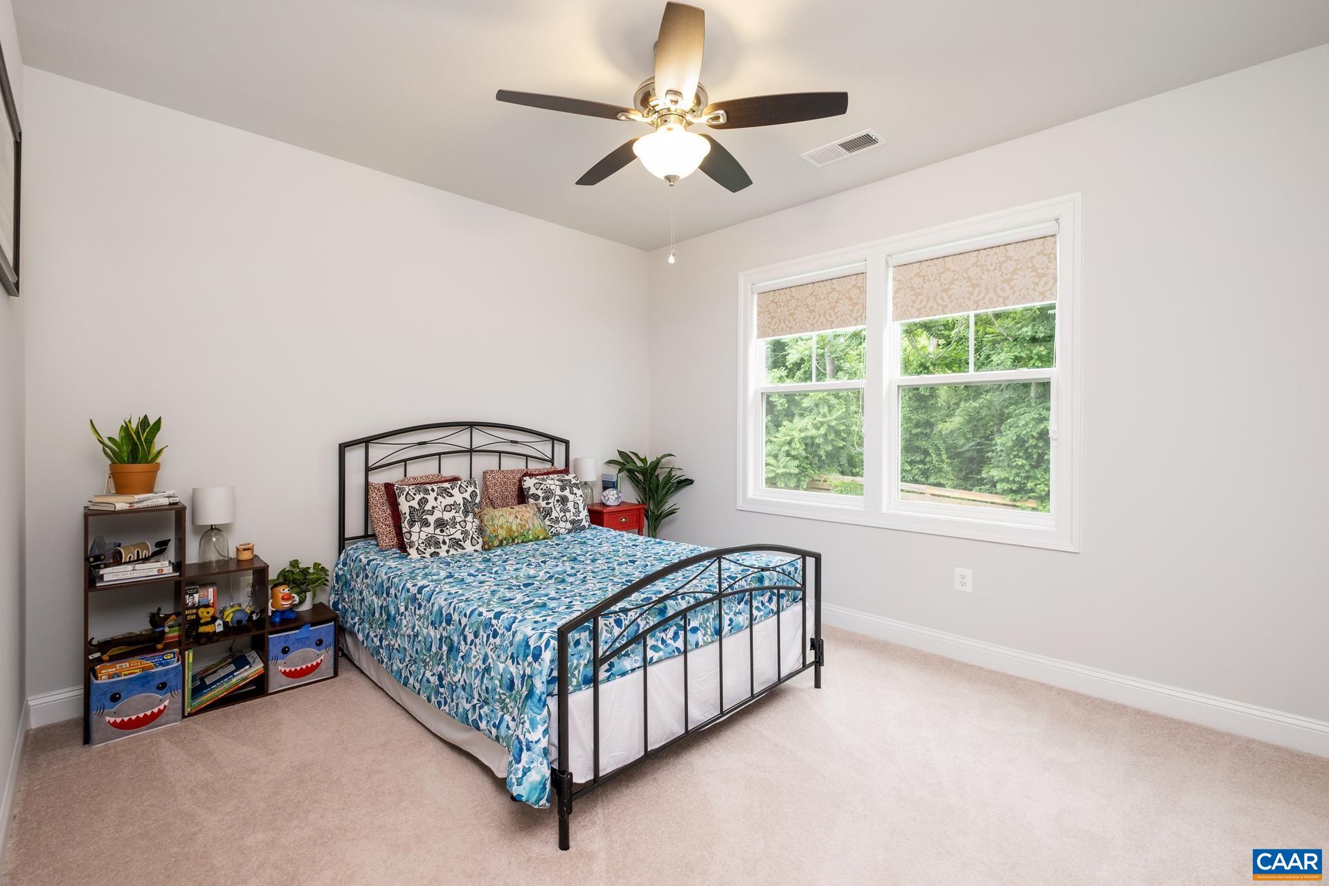 3232 Bergen Street Charlottesville, VA 22902 - Photo 14 of 31 a bedroom with a bed chandelier and a window