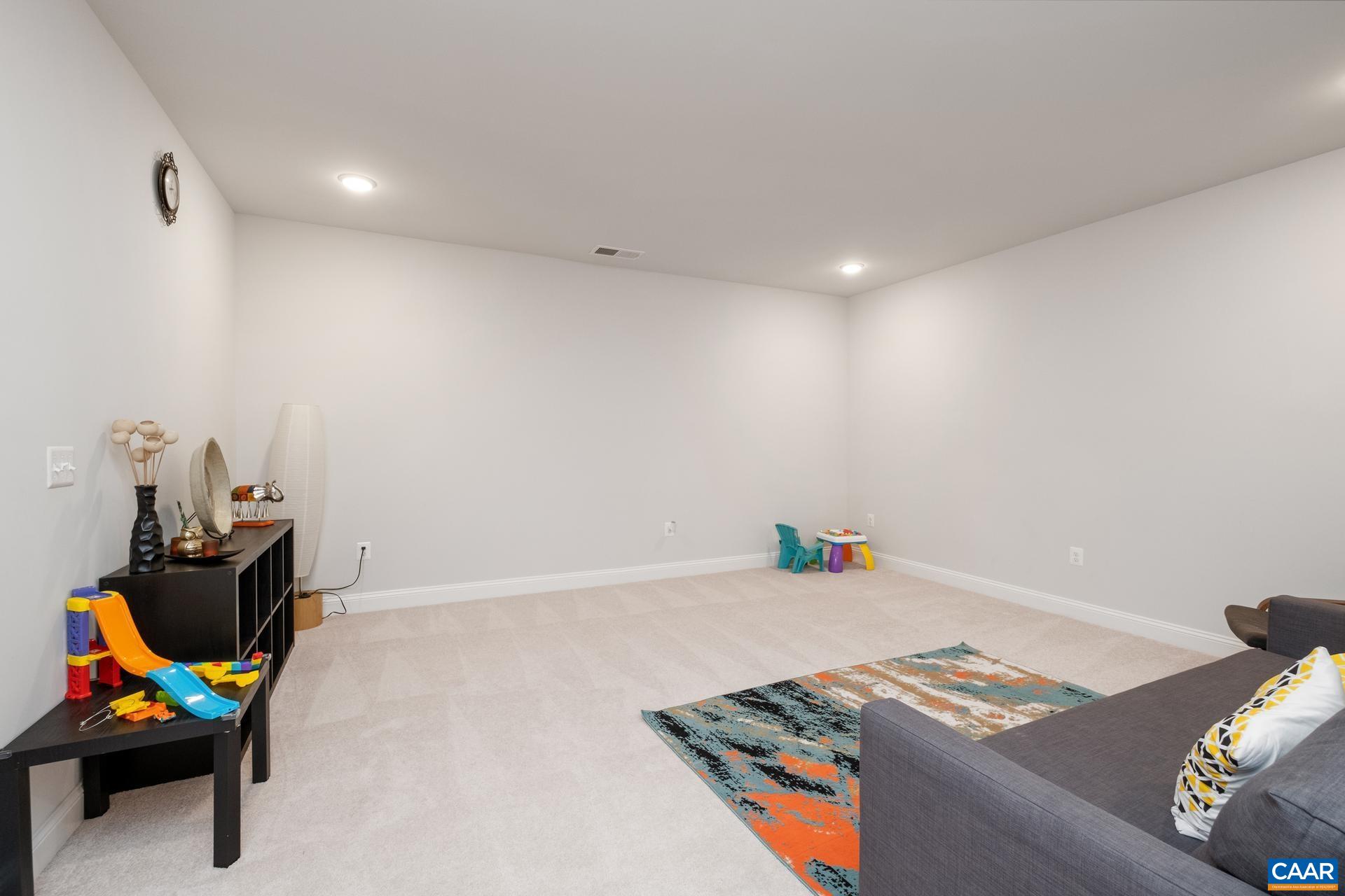 3232 Bergen Street Charlottesville, VA 22902 - Photo 19 of 31 a bedroom with a bed and a chandelier
