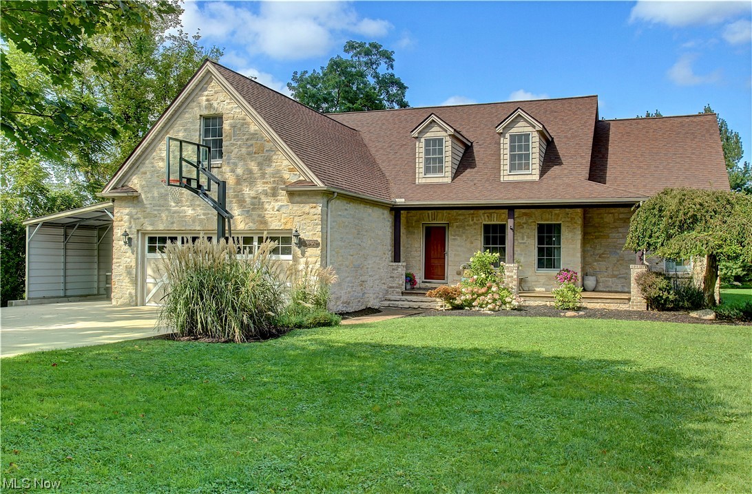 View of front of property featuring garage and a front lawn