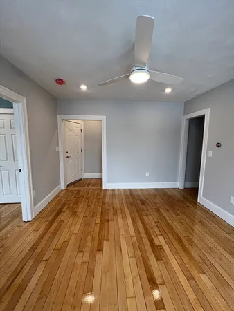 a view of an empty room and wooden floor