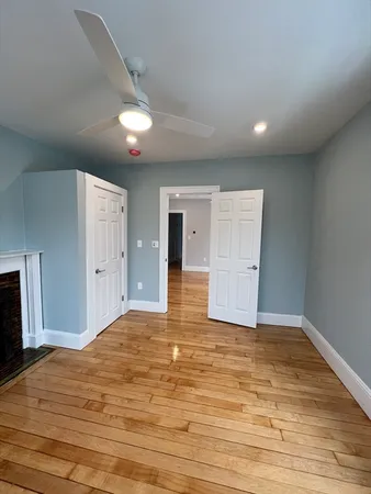 a view of empty room with wooden floor