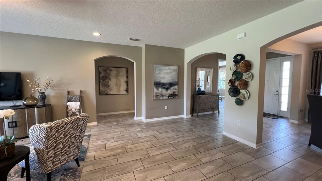 714 Riviera Bella Drive DeBary, FL 32713 - Photo 13 of 50 a view of a livingroom with furniture and a flat screen tv