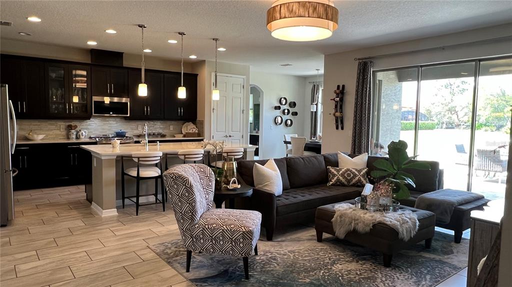 714 Riviera Bella Drive DeBary, FL 32713 - Photo 14 of 50 a living room with furniture kitchen view and a large window