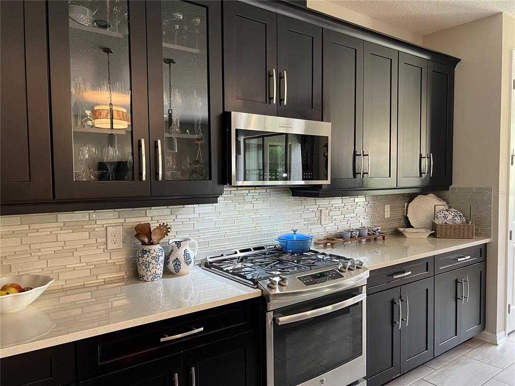 714 Riviera Bella Drive DeBary, FL 32713 - Photo 17 of 50 a kitchen with stainless steel appliances granite countertop a sink stove and cabinets