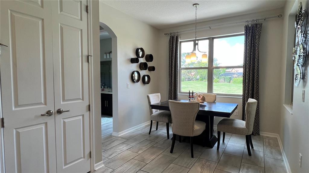 714 Riviera Bella Drive DeBary, FL 32713 - Photo 19 of 50 a view of a dining room with furniture window and outside view