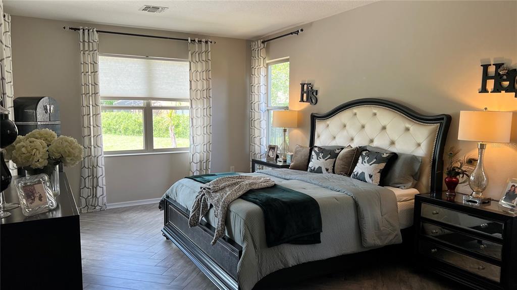 714 Riviera Bella Drive DeBary, FL 32713 - Photo 21 of 50 a bed sitting in a bedroom next to a window