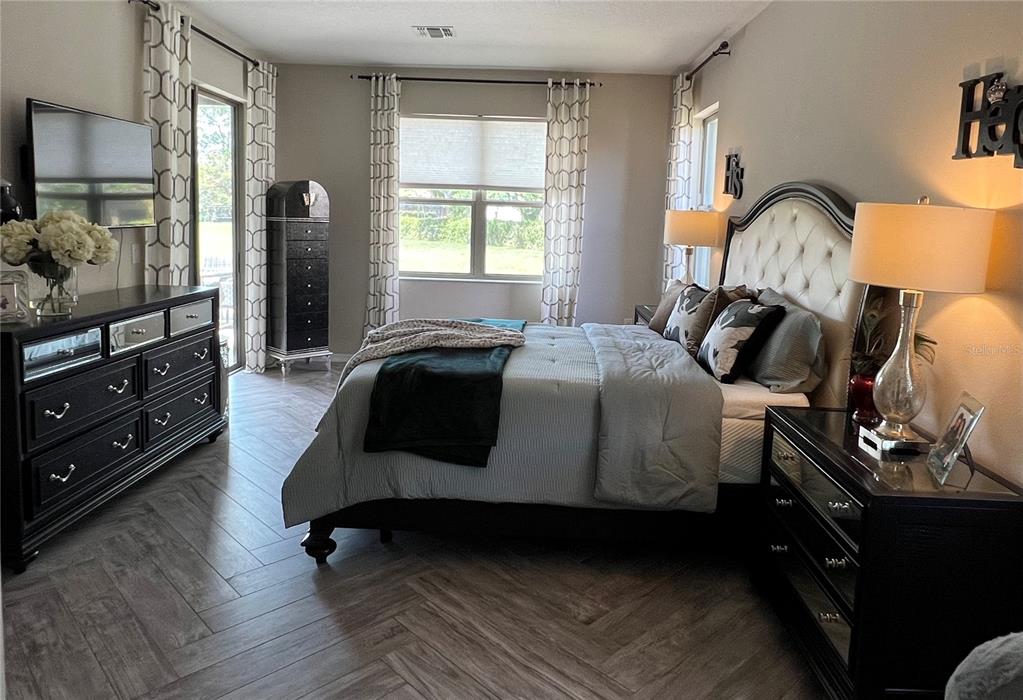 714 Riviera Bella Drive DeBary, FL 32713 - Photo 22 of 50 a bedroom with a bed window and dresser
