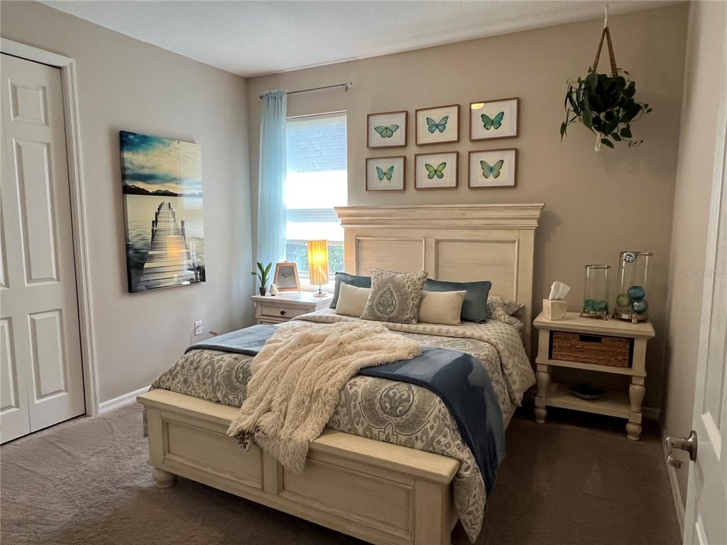 714 Riviera Bella Drive DeBary, FL 32713 - Photo 24 of 50 a bedroom with a bed and a painting on the wall