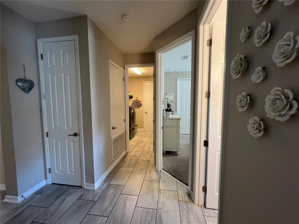 714 Riviera Bella Drive DeBary, FL 32713 - Photo 28 of 50 a view of a hallway with wooden floor