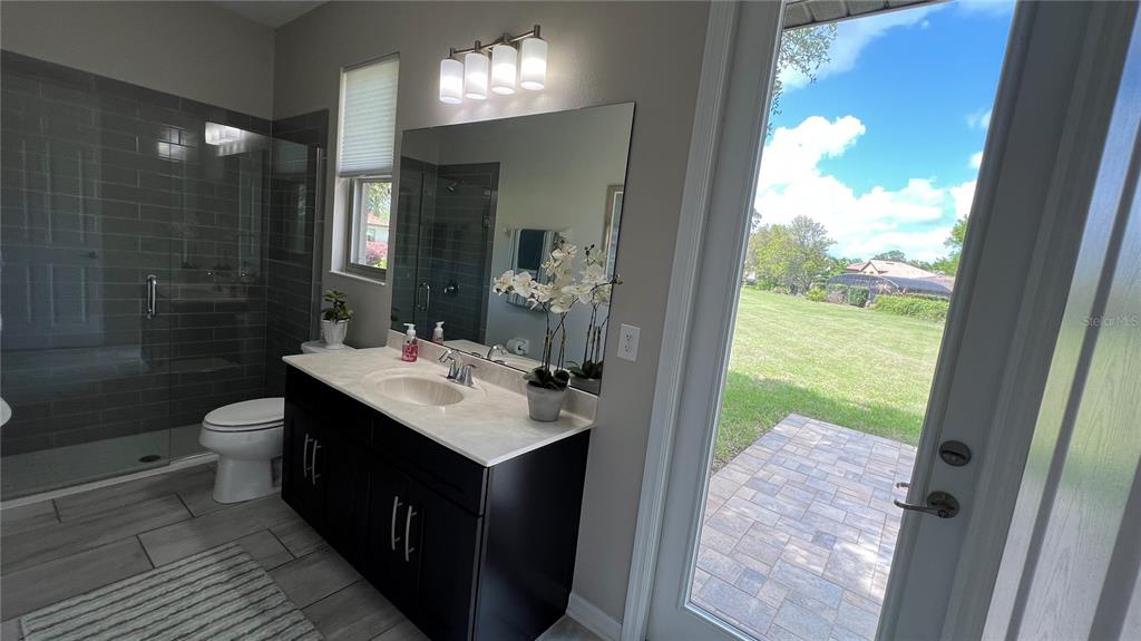 714 Riviera Bella Drive DeBary, FL 32713 - Photo 29 of 50 a bathroom with a sink mirror vanity and toilet