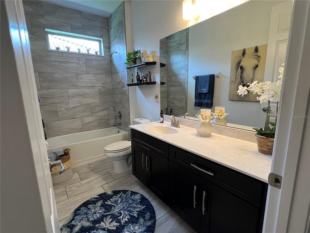 714 Riviera Bella Drive DeBary, FL 32713 - Photo 32 of 50 a bathroom with a double vanity sink toilet and shower