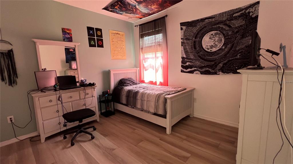 714 Riviera Bella Drive DeBary, FL 32713 - Photo 33 of 50 a bedroom with a bed and a chair in it