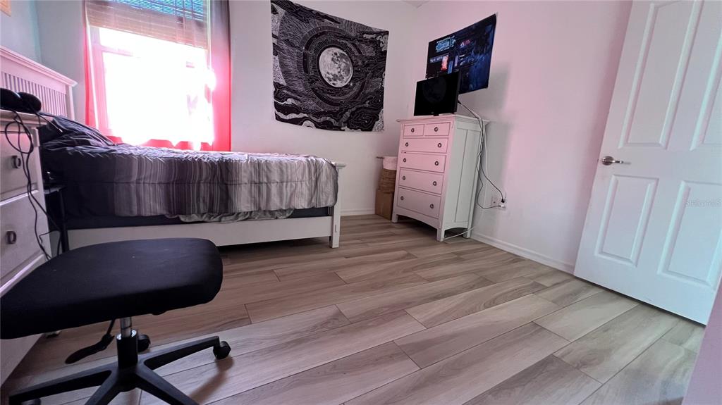 714 Riviera Bella Drive DeBary, FL 32713 - Photo 34 of 50 a bedroom with a chair and bed