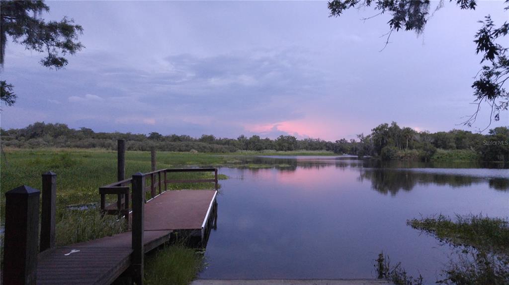 714 Riviera Bella Drive DeBary, FL 32713 - Photo 49 of 50 a view of a lake with a table and chairs