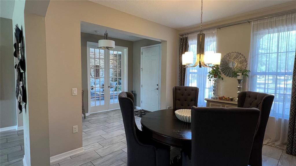 714 Riviera Bella Drive DeBary, FL 32713 - Photo 8 of 50 a dining room with furniture and wooden floor
