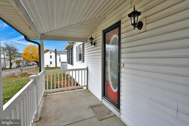 a view of a porch with wooden floor and iron fence