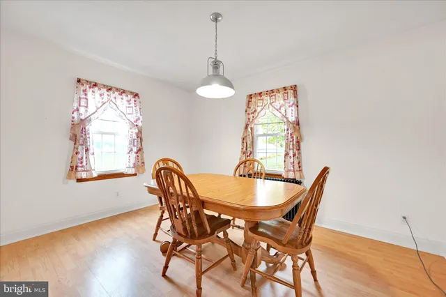 a dining room with furniture and window
