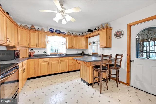 a kitchen with stainless steel appliances granite countertop a stove a sink dishwasher a microwave oven with granite countertops and cabinets