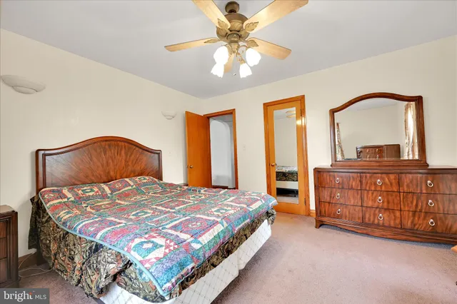 a bedroom with a bed and a dresser