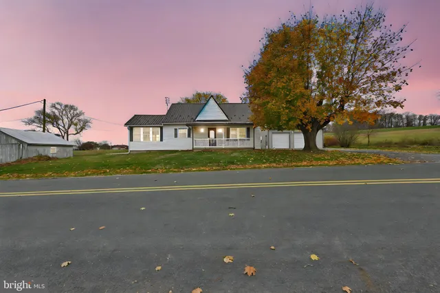 a front view of a house with a yard and street view