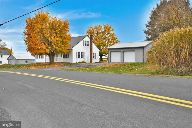 a view of a house with a yard and palm trees
