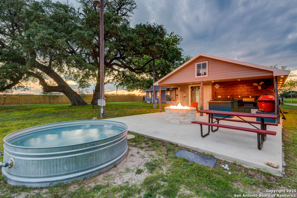 a swimming pool with outdoor seating yard and green space