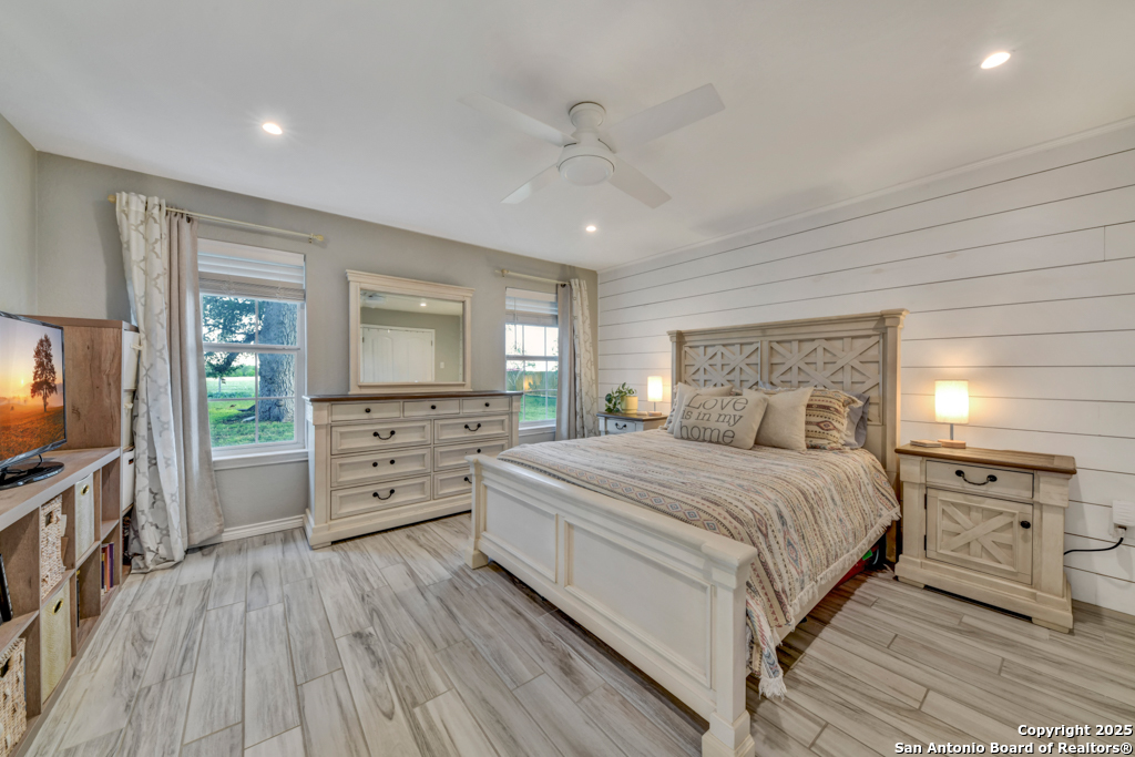 15592 Miller Road St. Hedwig, TX 78152 - Photo 15 of 47 a bedroom with a bed and a flat screen tv