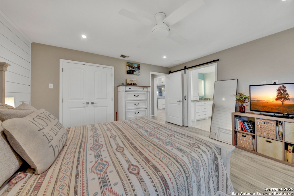 15592 Miller Road St. Hedwig, TX 78152 - Photo 16 of 47 a bedroom with a bed and a flat screen tv