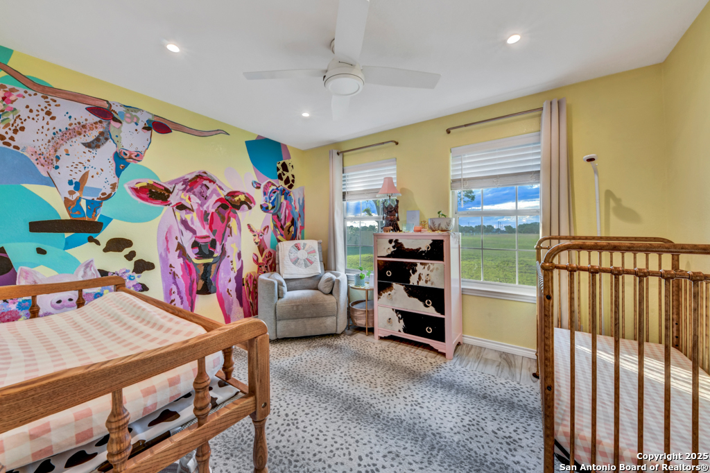 15592 Miller Road St. Hedwig, TX 78152 - Photo 20 of 47 a bedroom with furniture and a flat screen tv