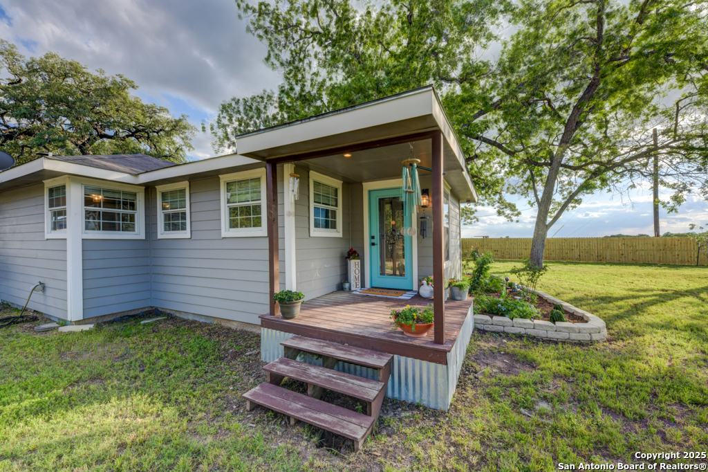 15592 Miller Road St. Hedwig, TX 78152 - Photo 32 of 47 a view of a wooden bench sitting in backyard of house