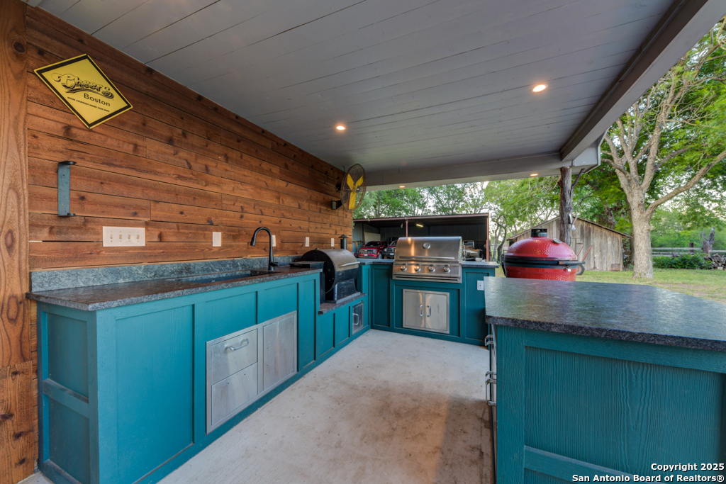 15592 Miller Road St. Hedwig, TX 78152 - Photo 37 of 47 a kitchen with stainless steel appliances granite countertop a stove and a sink