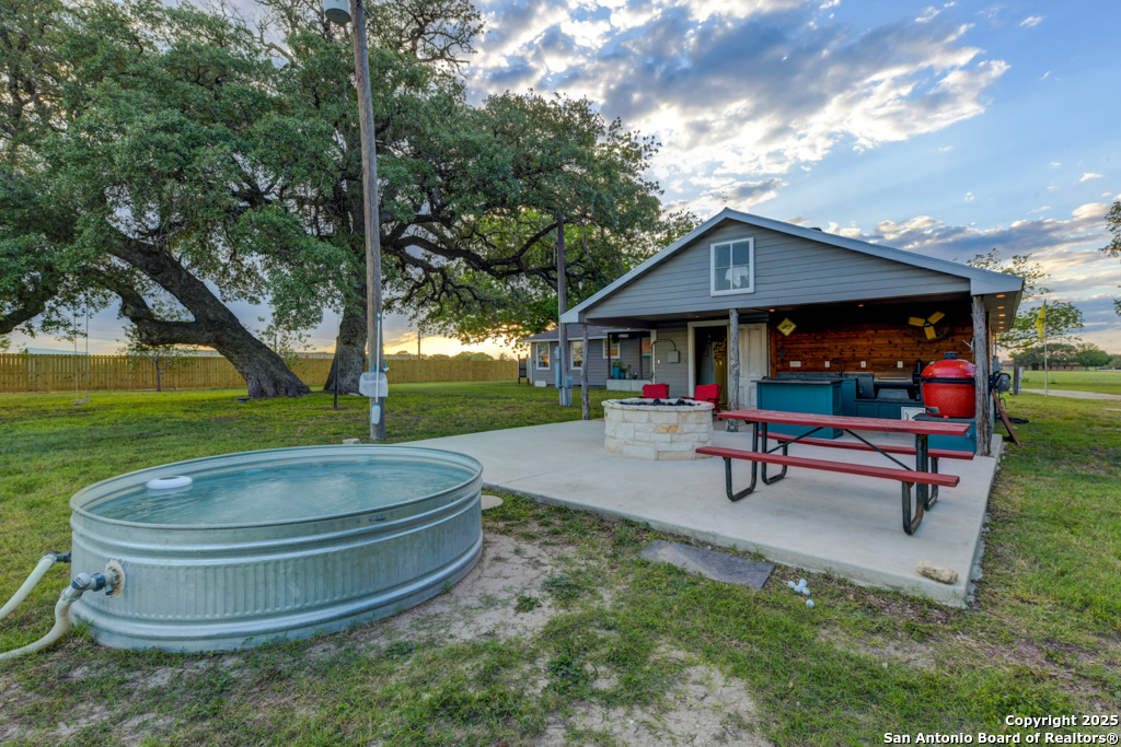 15592 Miller Road St. Hedwig, TX 78152 - Photo 40 of 47 a backyard of a house with barbeque oven table and chairs