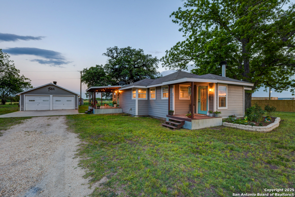 15592 Miller Road St. Hedwig, TX 78152 - Photo 4 of 47 a front view of a house with garden
